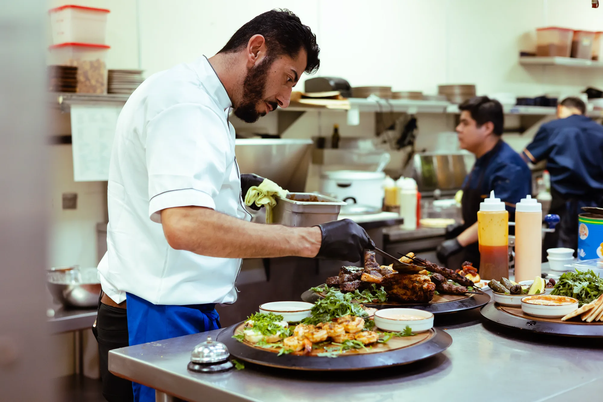 Kalimera chef plating dishes in the kitchen