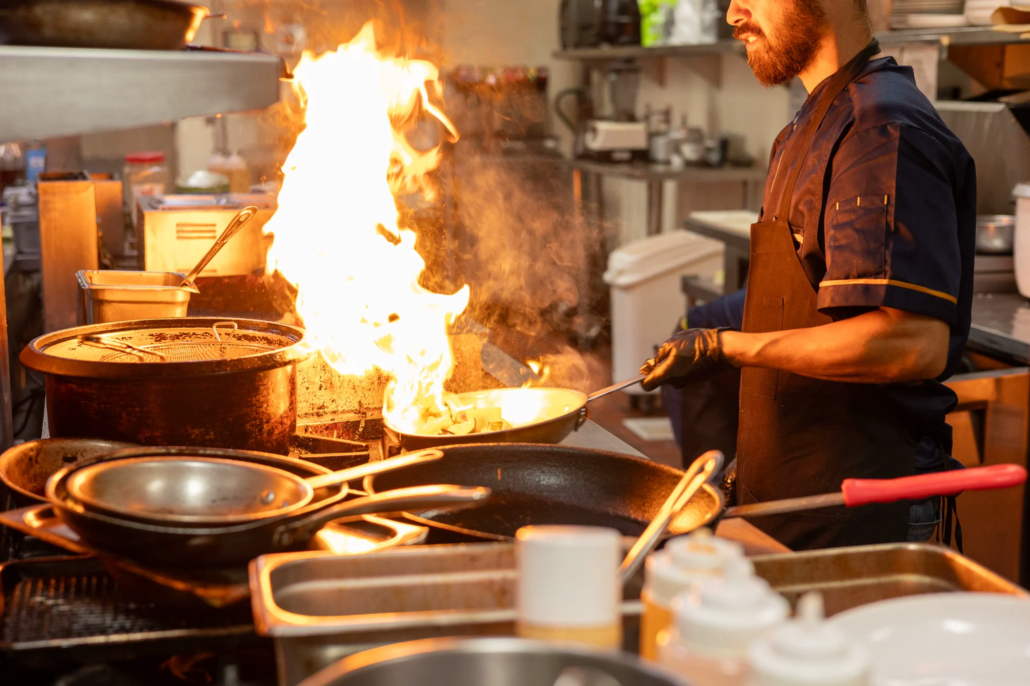 Chef cooking over an open flame